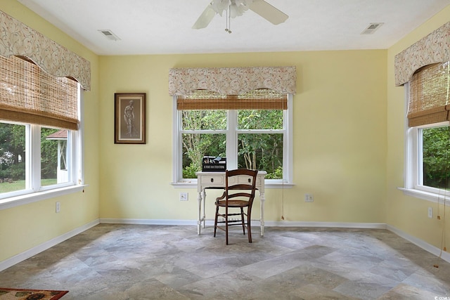 living area with ceiling fan, a wealth of natural light, and tile patterned floors