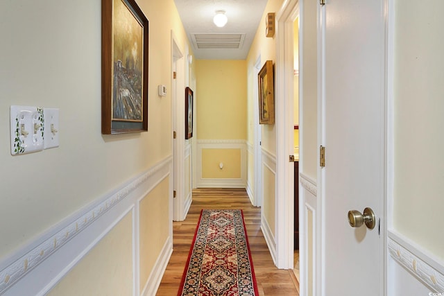 hallway featuring light hardwood / wood-style flooring and a textured ceiling