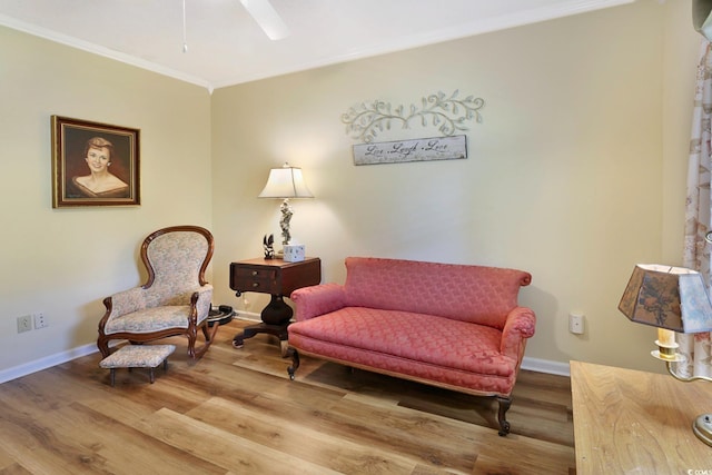 sitting room featuring hardwood / wood-style flooring, crown molding, and ceiling fan