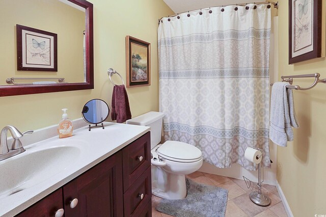 bathroom with toilet, tile patterned flooring, and vanity