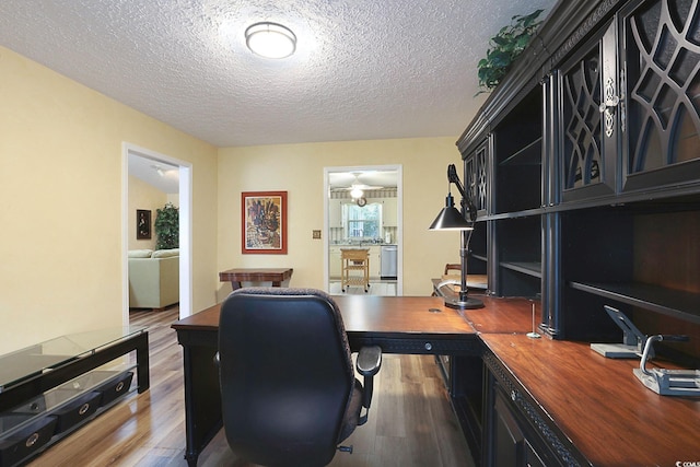 office featuring a textured ceiling and dark hardwood / wood-style flooring