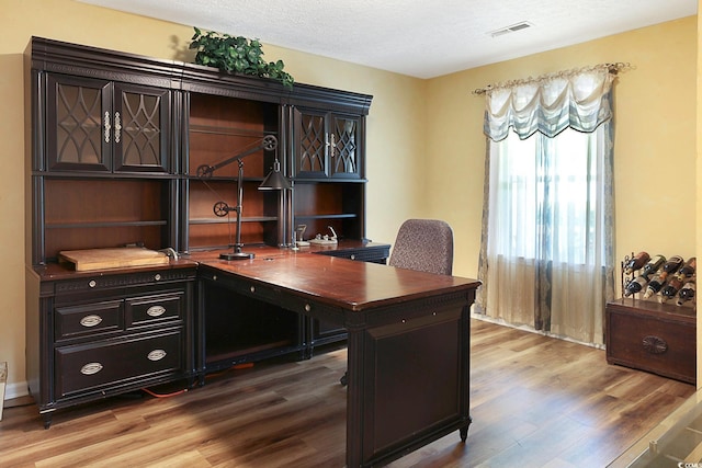 office with a textured ceiling and hardwood / wood-style flooring