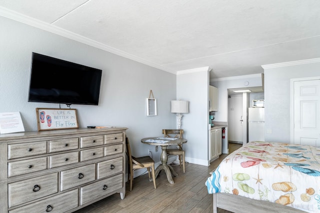 bedroom with white refrigerator, hardwood / wood-style floors, and ornamental molding