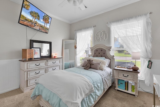 carpeted bedroom featuring ceiling fan, ornamental molding, and multiple windows