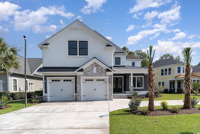 view of front of home with a garage and a front lawn