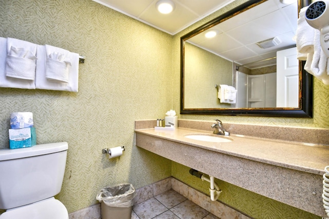 bathroom with tile patterned flooring, sink, and toilet