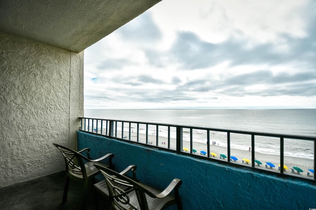 balcony with a view of the beach and a water view