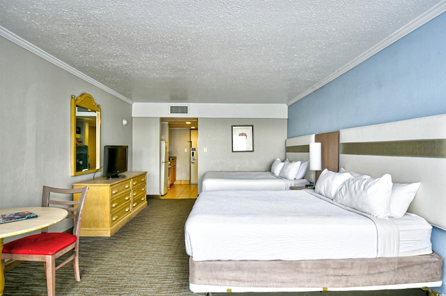 carpeted bedroom with a textured ceiling and ornamental molding