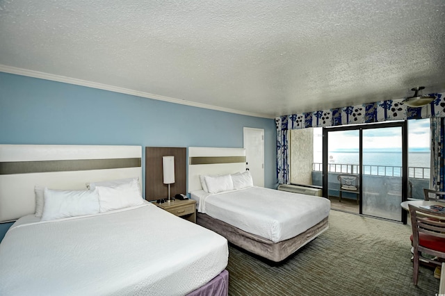 bedroom with a water view, carpet floors, access to exterior, a textured ceiling, and ornamental molding