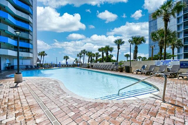 view of swimming pool with a patio