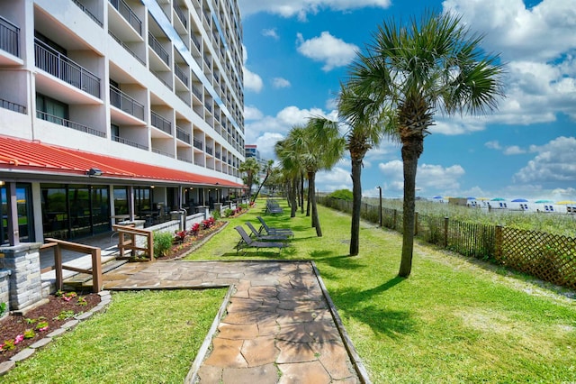 view of home's community with a lawn and a patio