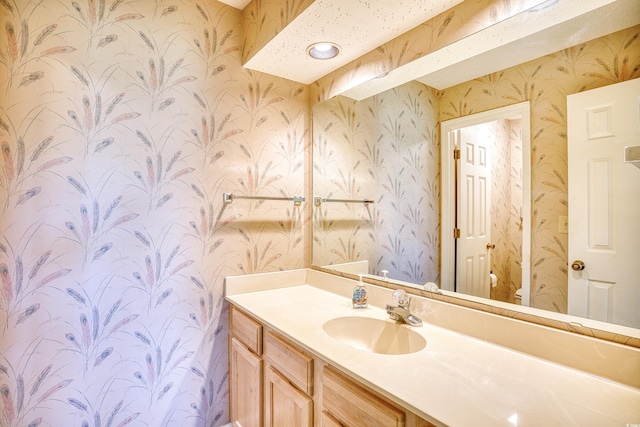 4103 Pinehurst Cir Unit Bb-12, Little River, SC 29566 - bathroom featuring wallpapered walls and vanity