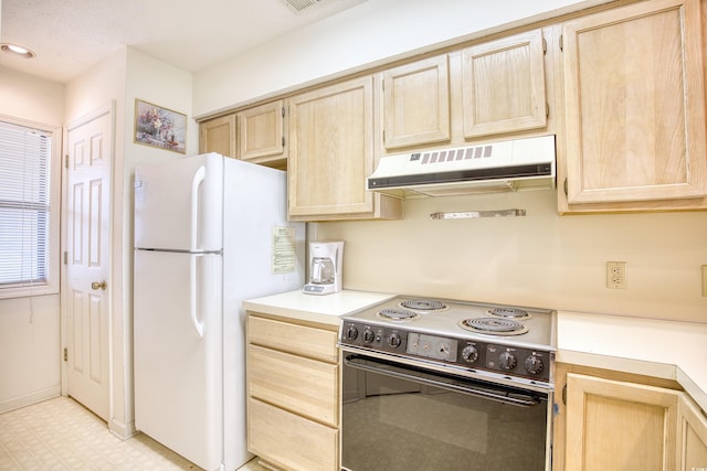 kitchen with light brown cabinets, white appliances, and light tile patterned floors