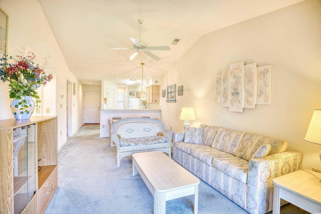 carpeted living room with ceiling fan and lofted ceiling