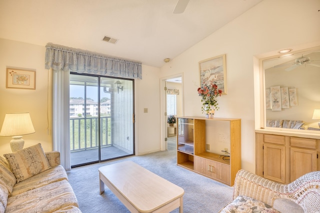 carpeted living room with ceiling fan and lofted ceiling