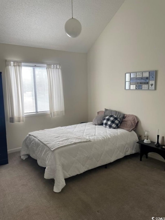 bedroom featuring a textured ceiling, carpet floors, and lofted ceiling