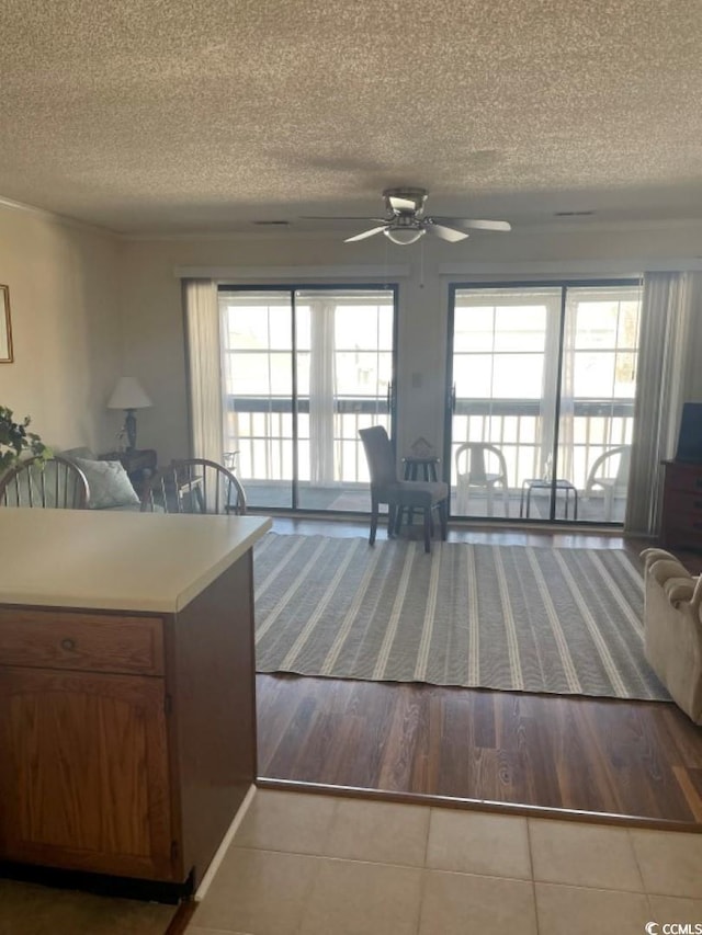 kitchen with tile patterned flooring, a textured ceiling, and ceiling fan