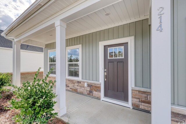 foyer entrance with hardwood / wood-style floors, crown molding, and plenty of natural light