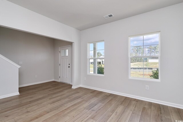 foyer featuring hardwood / wood-style floors and ornamental molding