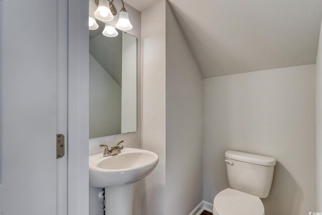 bedroom featuring ceiling fan, vaulted ceiling, and dark wood-type flooring