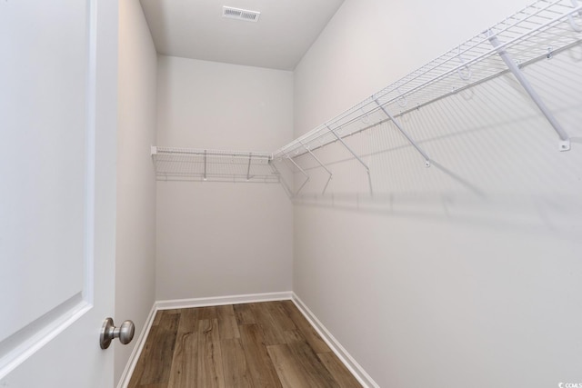 spacious closet with hardwood / wood-style floors