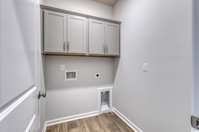 laundry area featuring hardwood / wood-style flooring, electric dryer hookup, cabinets, and washer hookup