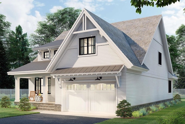 modern farmhouse featuring a garage and covered porch