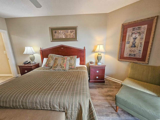 bedroom with ceiling fan and wood-type flooring