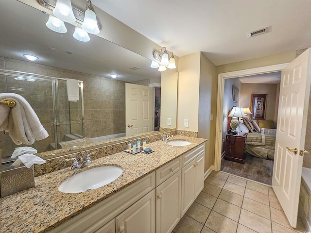 bathroom with vanity, a shower with door, and tile patterned flooring