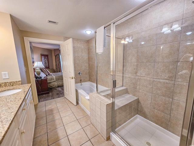 bathroom featuring tile patterned flooring, plus walk in shower, and vanity