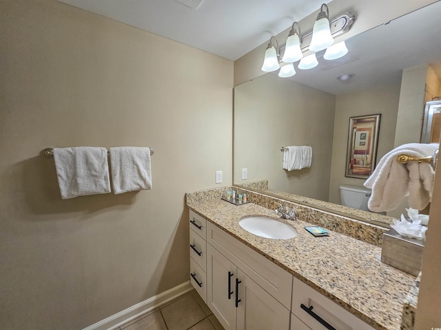 bathroom with vanity, toilet, and tile patterned flooring