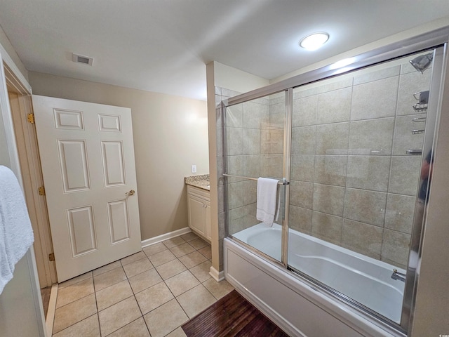 bathroom featuring tile patterned floors, vanity, and shower / bath combination with glass door