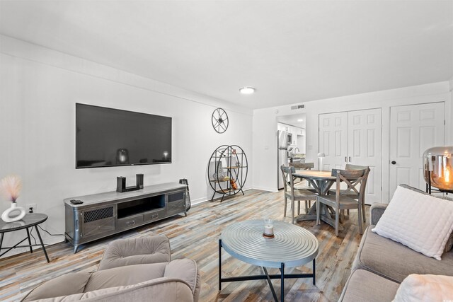7509 N Ocean Blvd Unit 103, Myrtle Beach, SC 29572 - living area featuring wood finished floors and baseboards