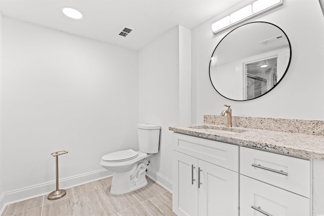 7509 N Ocean Blvd Unit 103, Myrtle Beach, SC 29572 - bathroom with baseboards, vanity, toilet, and a shower