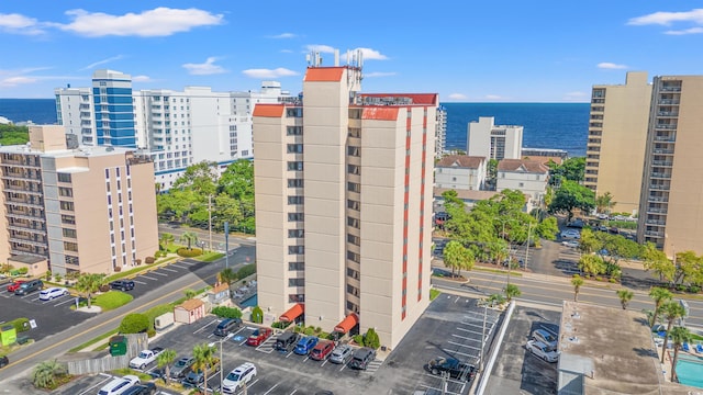 7509 N Ocean Blvd Unit 103, Myrtle Beach, SC 29572 - view of building exterior with uncovered parking, a water view, and a view of city