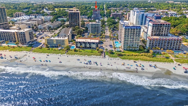 bird's eye view featuring a water view and a beach view