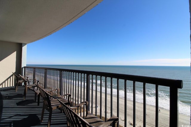 balcony with a beach view and a water view