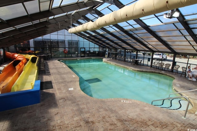 view of pool with glass enclosure