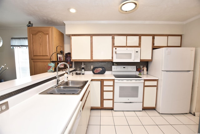 kitchen featuring white appliances, light tile patterned floors, crown molding, and sink