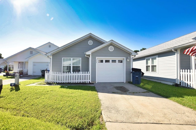 view of front of house featuring driveway, a garage, fence, and a front yard