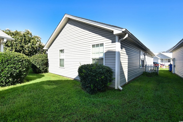 view of side of property with a lawn