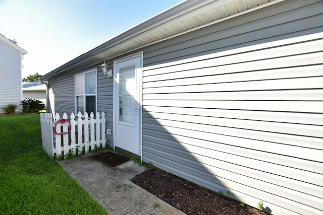 doorway to property featuring a yard