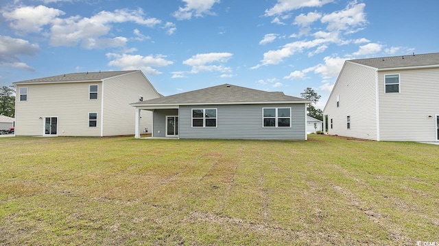 rear view of house with a yard