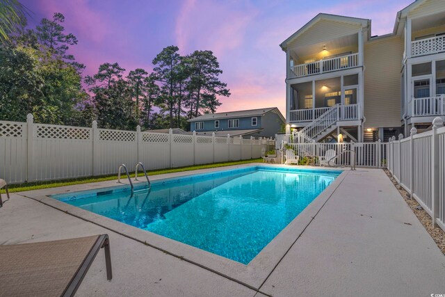 view of pool at dusk