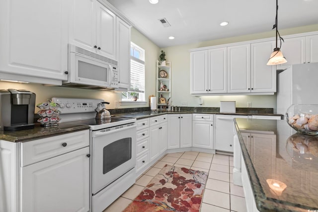 kitchen with light tile patterned floors, white appliances, white cabinetry, and pendant lighting