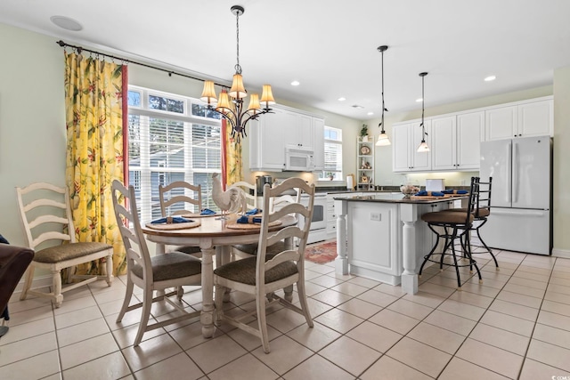 tiled dining space with a notable chandelier