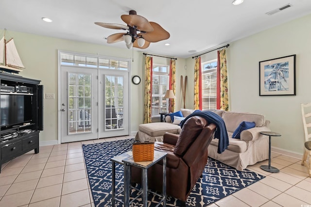 living room featuring ceiling fan and light tile patterned floors