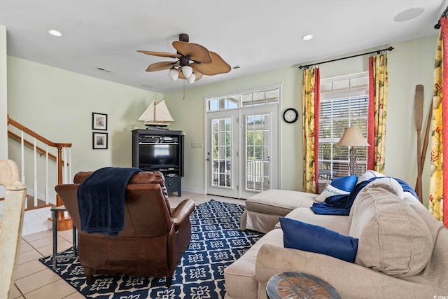 living room featuring light tile patterned flooring, plenty of natural light, and ceiling fan