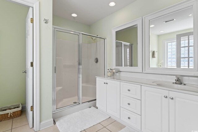 bathroom featuring tile patterned floors, vanity, and an enclosed shower