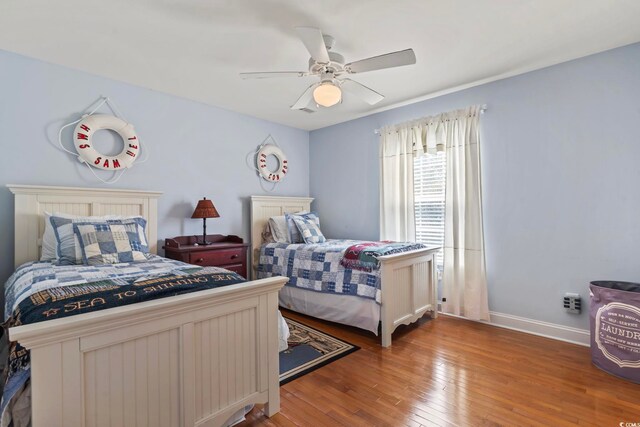 bedroom with ceiling fan and hardwood / wood-style flooring